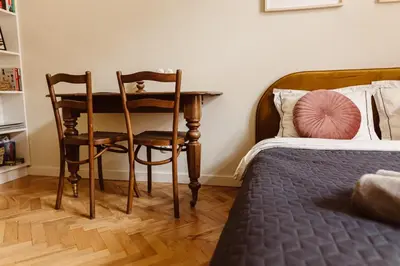 a bedroom with a table and two chairs and a bed at Apartament na Krakowskim Kazimierzu in Kraków