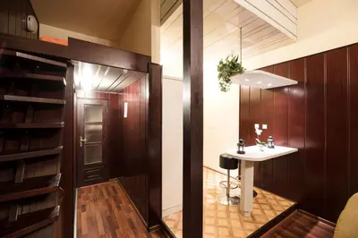 a bathroom with a sink and a table at Golden Lion Guest Rooms Szewska 19 in Kraków