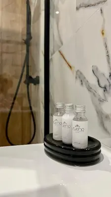 a group of four white bottles sitting on a table at Apartament 36 Zator by Housine in Zator
