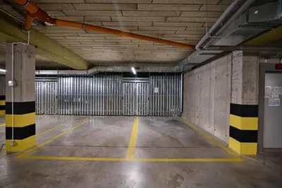 an empty parking garage with two garage doors at Apartament 36 Zator by Housine in Zator