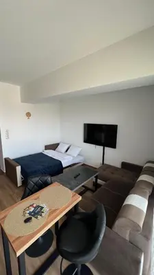 a living room with a bed and a couch at Apartament 36 Zator by Housine in Zator