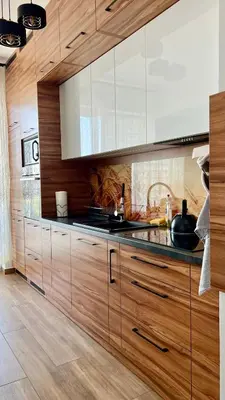 a kitchen with wooden cabinets and a counter top at Apartament 36 Zator by Housine in Zator