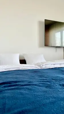 a large bed with a blue blanket on it at Apartament 36 Zator by Housine in Zator