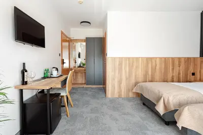 a hotel room with two beds and a table at Hotel Solny in Wieliczka