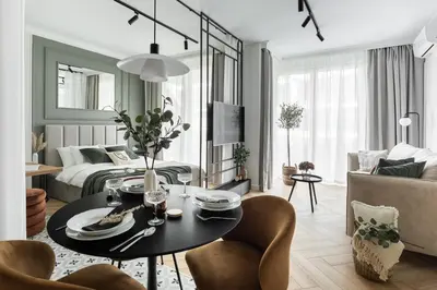 a living room with a table and chairs and a bedroom at #2 OLIVE Apartment City Center FREE GARAGE in Kraków