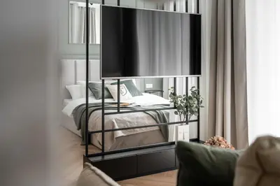 a bedroom with a bed and a large mirror at #2 OLIVE Apartment City Center FREE GARAGE in Kraków