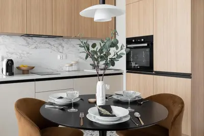 a kitchen with a black table with a vase of flowers at #2 OLIVE Apartment City Center FREE GARAGE in Kraków