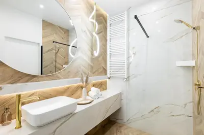 a bathroom with a sink and a mirror at #2 OLIVE Apartment City Center FREE GARAGE in Kraków