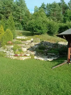 a garden with a stone path in the grass at Agroturystyka Leśna Ostoja Borek in Golczowice