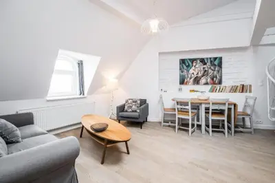 a living room with a table and a dining room at Urban Nest Apartments Bon 11 in Kraków
