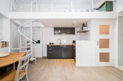 a kitchen with a loft bed and a table at Urban Nest Apartments Bon 11 in Kraków