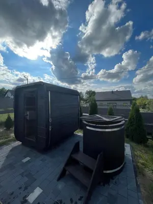 a black shed and a bench and a trash can at Nova 26 in Klucze