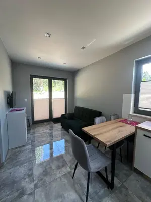a living room with a table and a couch at Nova 26 in Klucze