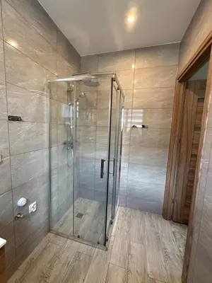 a shower with a glass door in a bathroom at Nova 26 in Klucze