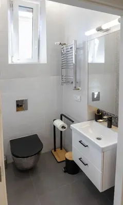 a white bathroom with a toilet and a sink at Old Cracow Apartment in Kraków