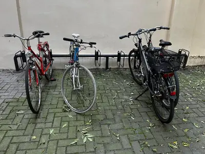 three bikes parked next to each other on a sidewalk at Old Cracow Apartment in Kraków