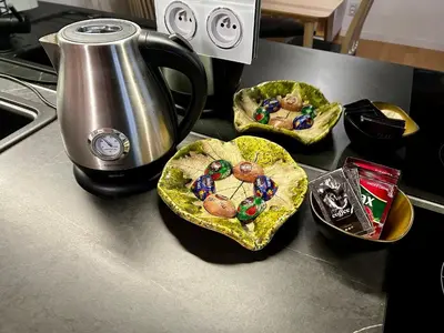 three bowls of food on a counter next to a kettle at Old Cracow Apartment in Kraków