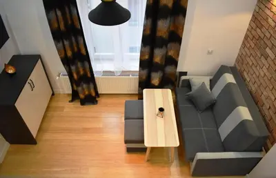a living room with a couch and a table at Old Cracow Apartment in Kraków