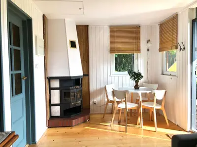 a small dining room with a table and chairs at Domek Pod Lasem in Trzciana
