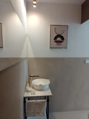 a bathroom with a bowl sink on a table at Alexa d'Oro Rooms in Kraków