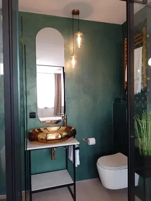 a bathroom with a sink and a mirror at Alexa d'Oro Rooms in Kraków