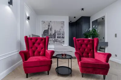 two red chairs and a table in a room at Apartament w centrum Krakowa 109 in Kraków