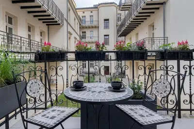 a patio with a table and chairs on a balcony at Apartament w centrum Krakowa 109 in Kraków