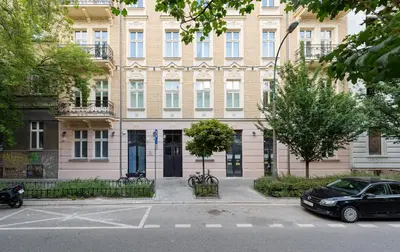 a large building with a car parked in front of it at Apartament w centrum Krakowa 109 in Kraków
