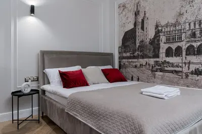 a bedroom with a large bed with red pillows at Apartament w centrum Krakowa 109 in Kraków