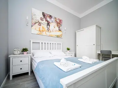 a bedroom with a bed with two towels on it at BARBICAN BY LANDMARK APARTMENTS in Kraków