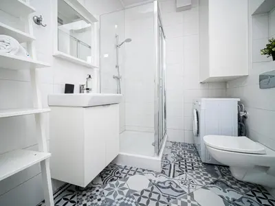 a bathroom with a toilet and a sink and a shower at BARBICAN BY LANDMARK APARTMENTS in Kraków