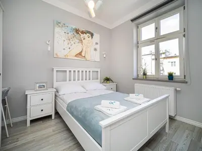 a bedroom with a bed with two towels on it at BARBICAN BY LANDMARK APARTMENTS in Kraków