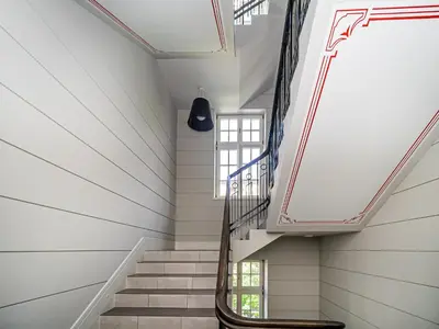 a staircase in a house with a window at BARBICAN BY LANDMARK APARTMENTS in Kraków
