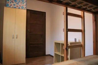 a bedroom with a wooden door and a closet at Dom na Książkowej in Jordanów