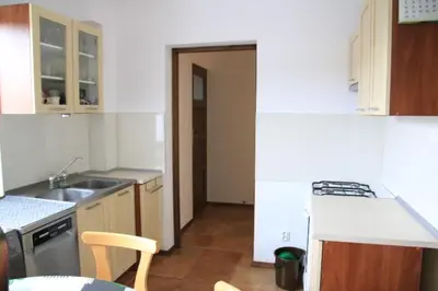 a small kitchen with a sink and a stove at Dom na Książkowej in Jordanów