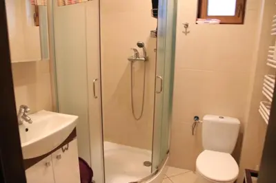 a bathroom with a shower and a toilet and a sink at Dom na Książkowej in Jordanów