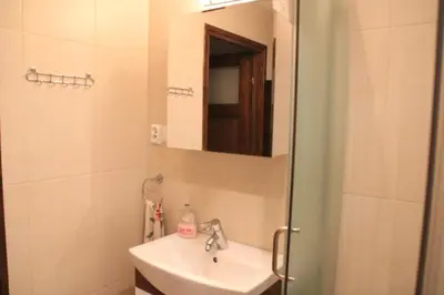 a bathroom with a sink and a mirror at Dom na Książkowej in Jordanów