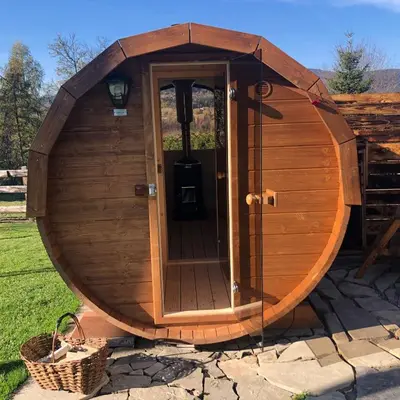 a wooden sauna with a wooden door in a yard at Agroturystyka Zagroda Miłkowskie in Słopnice