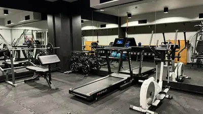 a gym with a lot of equipment in a room at Hotel Apis in Kraków
