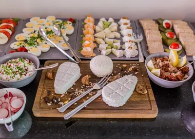 a table with many different types of food on it at Hotel Apis in Kraków