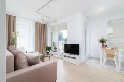 a living room with a couch and a tv at Apartment with Balcony & Parking Mogilska by Renters Prestige in Kraków