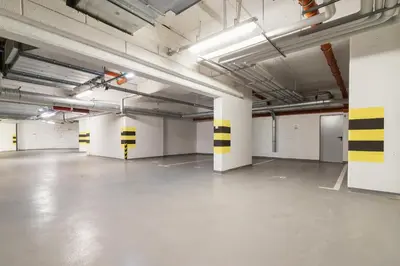 an empty garage with white and yellow stripes on the ceilings at Apartment with Balcony & Parking Mogilska by Renters Prestige in Kraków