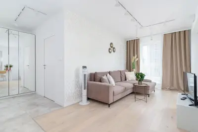 a living room with a couch and a tv at Apartment with Balcony & Parking Mogilska by Renters Prestige in Kraków