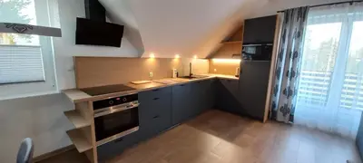 a small kitchen with a sink and a stove at Apartament Wierchy in Klikuszowa