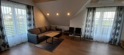 a living room with a couch and a table at Apartament Wierchy in Klikuszowa