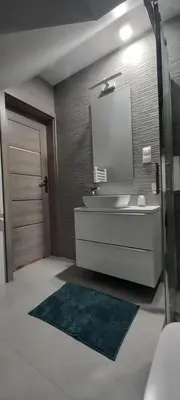 a bathroom with a sink and a mirror at Apartament Wierchy in Klikuszowa