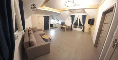 a living room with a couch and a table at Apartament Wierchy in Klikuszowa