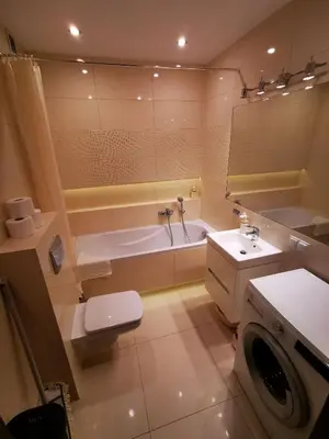 a bathroom with a tub and a toilet and a sink at Apartament Kraków Arena 20B in Kraków