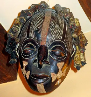 a wooden mask hanging on a wall at Globtroter Guest House in Kraków