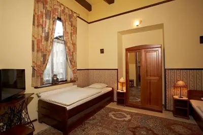 a bedroom with a bed and a window at Globtroter Guest House in Kraków